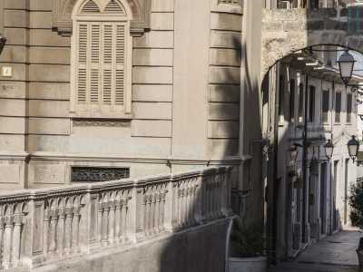 ...ecco aprirsi un piccolo arco in pietra sotto il quale si snoda una stradina in discesa puntellata da lampioncini: conduce direttamente in piazza del Mercantile, lasciandone intravedere uno scorcio
